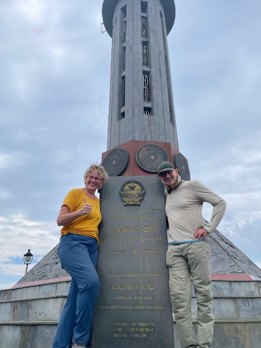 Tourists take photos at the foot of the flagpole